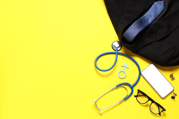 Male sign with stethoscope, smartphone and male accessories on yellow background. Prostate cancer...