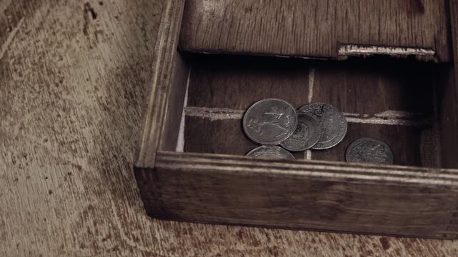 Vintage small coins in the wooden box