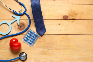 Male sign with heart, stethoscope, pills and tie on wooden background. Prostate cancer awareness...