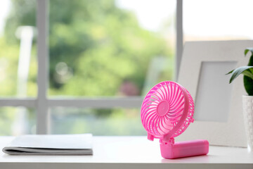 Small electric fan on table