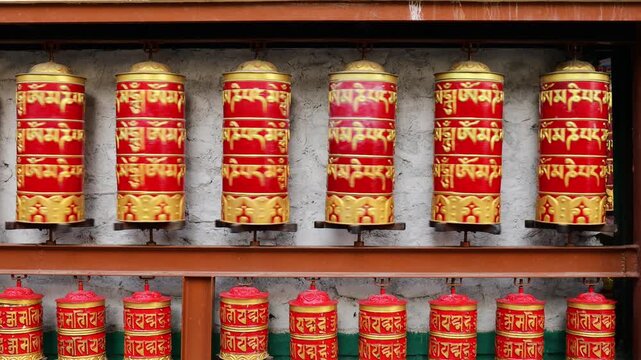 Rotating brass prayer wheels in Nepal monastery. Buddhist symbols, mantra engraving, spinning motion, cultural heritage, traditional ritual, spiritual architecture, Himalayas stock video