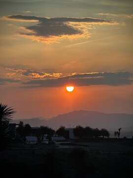 Sunset Over the Mountains With Dramatic Clouds and Silhouetted Landscape