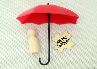 hand holding an umbrella with the question YPU NEED INSURANCE. insurance coverage concept