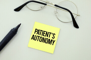  glasses and sign book with the word Patient's autonomy. medical concept