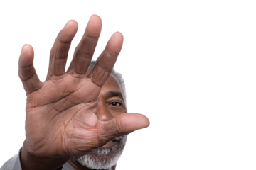 Close up of a man's hand covering his face, symbolizing secrecy, protection, or denial.