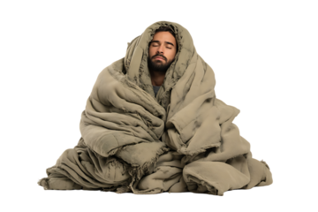 Man wrapped in a blanket, meditating or resting.