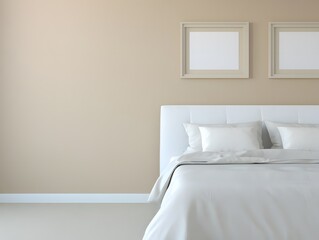 A minimalist bedroom with a white bed and two framed pictures on a neutral beige wall creating a serene and calming atmosphere for relaxation and sleep