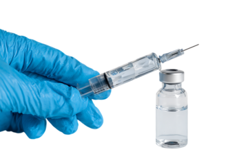 Close up of a hand in a blue glove drawing vaccine from a vial.