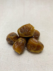 A vibrant close-up of a pile of delicious Sukkari dates (sukari dates), showcasing their golden-brown hue.