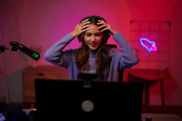 Young Asian Gamer Streamer Woman Plays Video Games Online Using Laptop Headphones Microphone Neon Light Setup Home Studio