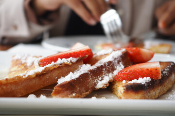 French toast with strawberries and powdered sugar