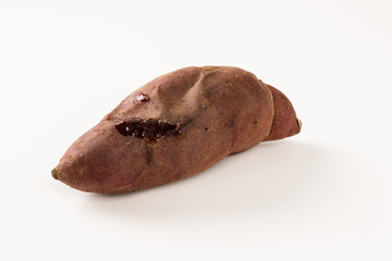 Obraz premium Roasted sweet potatoes on a white background