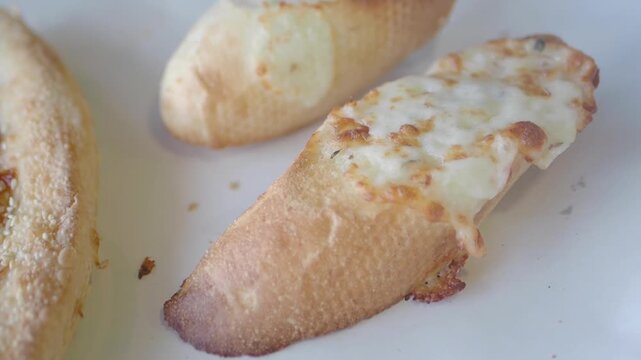 Freshly baked cheesy breadsticks topped with garlic