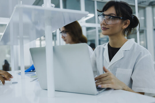 science technology chemist developing concept, female researcher, medical scientist or doctor or student use laptop in Modern Laboratory - Powered by Adobe