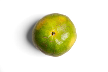 Top-down view of a fresh green tangerine, isolated on white with a soft shadow. Common in Thailand, this unique citrus is perfect for exotic food, travel, or wellness themes.