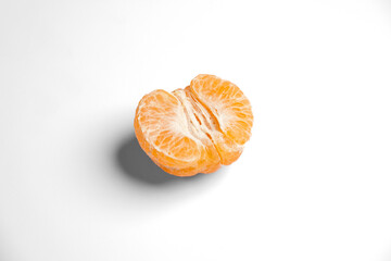 A peeled tangerine with a soft shadow, isolated on a clean white background. This realistic shot...
