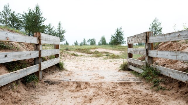 High-resolution photo of a wide wooden entrance leading to an outdoor military obstacle course with sand and grass, bathed in natural sunlight.