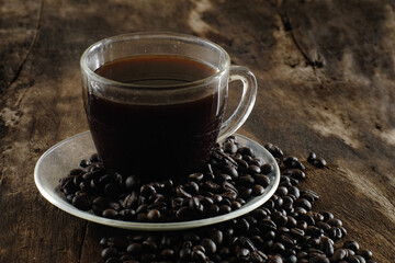 Cup of coffee on wooden table with copy space background, Half cup of coffee, Still life and sketch in dark tones, Top view for advertising, Business and Drink Concept