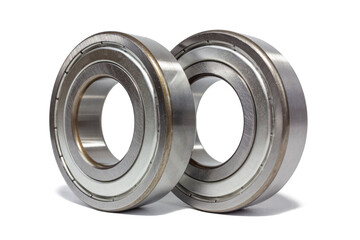 Two shiny metal ball bearings are isolated on a crisp white background.