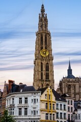 Fototapeta premium Explore the architectural beauty of Antwerp, Belgium. Admire the Gothic tower of the Cathedral of Our Lady, a symbol of the city s rich heritage and stunning architecture.
