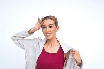 Southeast Asian woman wipes her forehead and fans her coat to cool down, expressing exhaustion and...