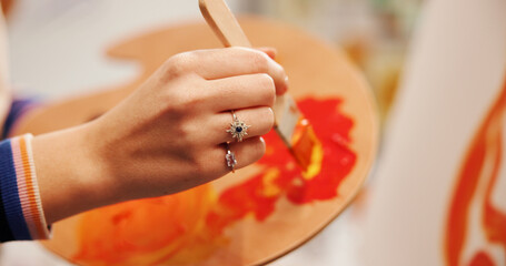 Hands, paintbrush and palette with painter in studio apartment for creative expression or...