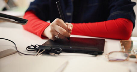 Drawing pad, stylus and hands of person in office for animation software, digital art and frame...