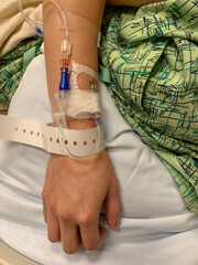 A patient's arm with an IV drip.