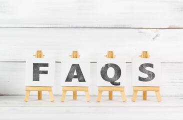 FAQs Acronym Displayed on Wooden Easels: Frequently Asked Questions Concept