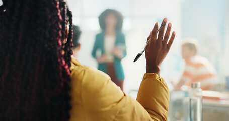 Woman, student and hands raised with teacher for question, engagement or interaction in classroom....