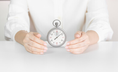 Hands Holding Stopwatch Representing Time Management, Deadline Awareness and Timing Protection