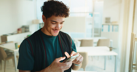 Education, student and happy man with phone in university classroom for course information. Mobile,...