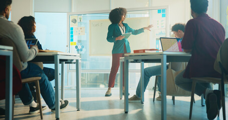 College, lecturer and education with students, woman and feedback with communication. People, tablet and teacher with discussion, university and learning with knowledge, exam schedule and teaching