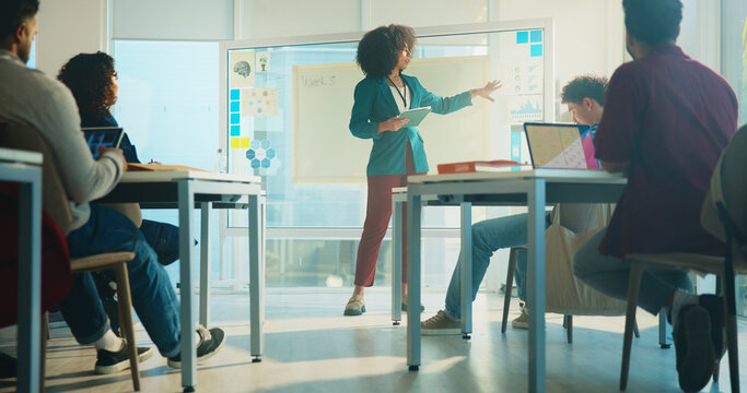 College, lecturer and education with students, woman and feedback with communication. People, tablet and teacher with discussion, university and learning with knowledge, exam schedule and teaching - Powered by Adobe