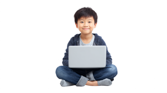 A young boy is sitting on the floor with a laptop in front of him