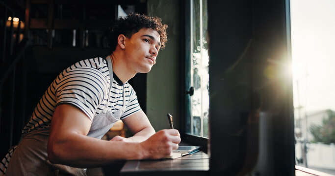 Thinking, barista and man writing notes in cafe for inventory list, stock or planning menu. Reflection, coffee shop or small business owner with journal for ideas, sales checklist or vision by window