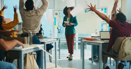 Students, throw paper and celebration in classroom with teacher, success and achievement at university. College professor, men and women with exam documents, test results and goals with education