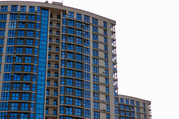 A very tall building constructed with numerous windows and balconies