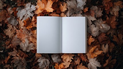 Aerial view of blank white book mockup on colorful autumn leaves background, banner with copy space