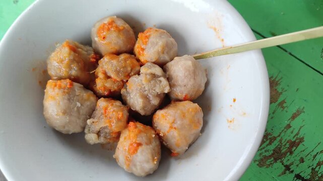 Bakso is one of the most popular street foods in Indonesia, consisting of savory meatballs made from beef, served in a hot broth with noodles, vegetables, and fried shallots. 