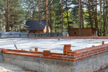Concrete slab of foundation of house with laid pipes start of construction on project. Construction...