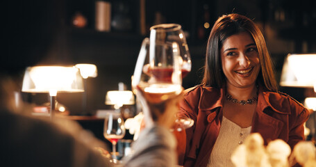 Woman, celebration and toast on date at restaurant with wine glass, cheers and bonding for...