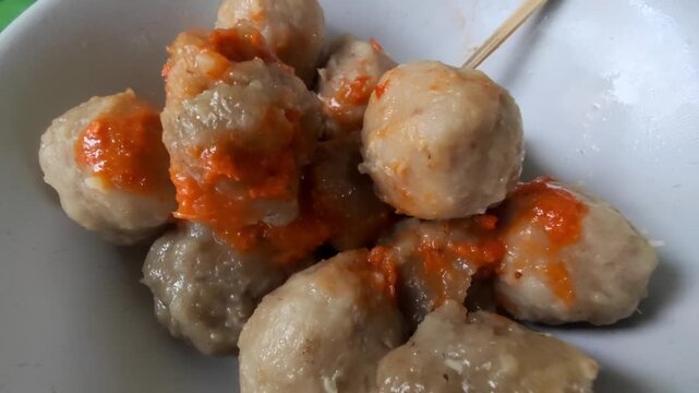 Bakso is one of the most popular street foods in Indonesia, consisting of savory meatballs made from beef, served in a hot broth with noodles, vegetables, and fried shallots. 