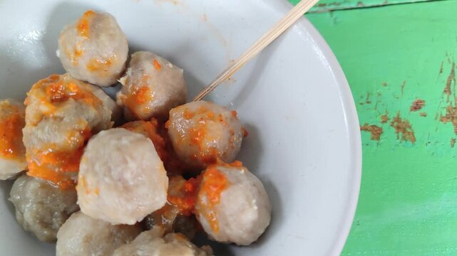 Bakso is one of the most popular street foods in Indonesia, consisting of savory meatballs made from beef, served in a hot broth with noodles, vegetables, and fried shallots. This traditional dish is 