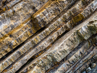 Diagonal patterns in layers of rock on a seaside cliff on the coast of Northern California