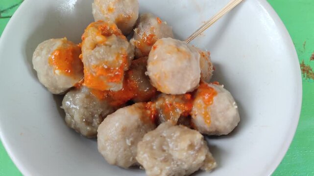 Bakso is one of the most popular street foods in Indonesia, consisting of savory meatballs made from beef, served in a hot broth with noodles, vegetables, and fried shallots. This traditional dish is 
