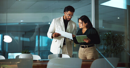 Businessman, woman and tablet with documents, night and financial review with deadline at office....
