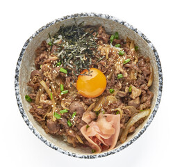 Bowl of Japanese gyudon featuring thinly sliced beef, caramelized onions, and raw egg yolk on top of steamed rice, garnished with seaweed, sesame seeds, green onions, and pickled ginger