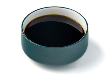 Bowl of Black Shabu Soup, teal colored ceramic dish, placed white background. rich, glossy texture of sauce contrasts with smooth, matte finish of bowl, creating minimalist and elegant