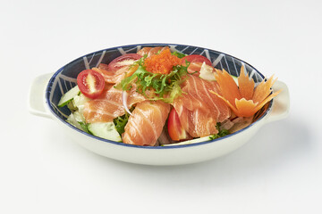 Bowl of fresh salmon sashimi salad garnished with vibrant vegetables, cherry tomatoes, cucumber slices, lettuce, and topped with fish roe, served in decorative ceramic dish